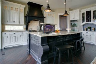 Custom Island in Kitchen with Integrated Monitor in Counter Top