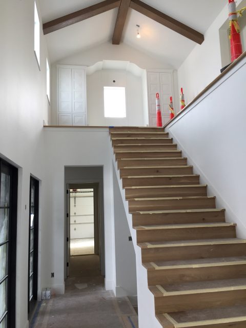 Staircase with Shaped Sheet Rock Ceiling at the top of the landing